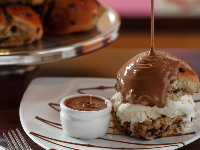 The Max Brenner Not Cross Bun includes a fresh bun, filled with vanilla ice cream and drizzled in milk chocolate.
