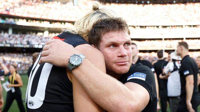 An emotional Taylor Adams was consoled by Collingwood captain Darcy Moore after the Magpies won the 2023 AFL premiership. Picture: Michael Willson / Getty Images