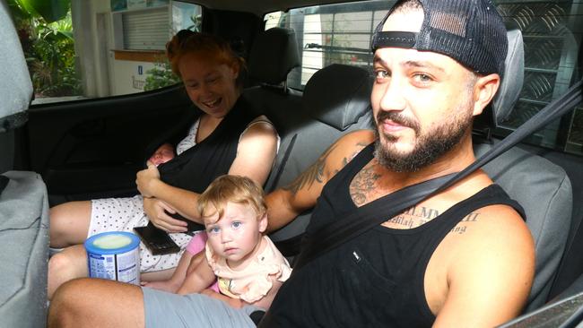 Jess with seven day old Lisa and Darrell with 12-month-old daughter Delilah get evacuated by the SES from the Cairns Beach Resort in Holloways Beach. Picture: Peter Carruthers