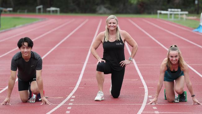 Melinda Gainsford-Taylor on the track at the at Sydney Academy of Sport in February 2020, with two runners she trains, Scott Wong, 17, and Sally Priest, 15. Picture: Ryan Osland