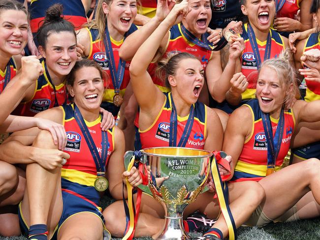 Chelsea Randall, front left, surrounded by her Adelaide teammates with the premiership cup after they beat Carlton by 45 points in the 2019 AFLW grand final at Adelaide Oval in front of a record crowd of 53, 034. Picture: Tom Huntley