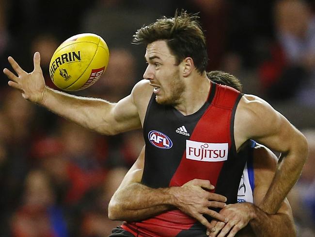 AFL Round 16. North Melbourne vs Essendon at Etihad Stadium. Michael Hibberd under pressure . Pic: Michael Klein