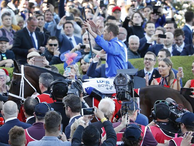 Three times a legend: Winx and jockey Hugh Bowman return to scale to approval of an adoring crowd. Picture: David Caird