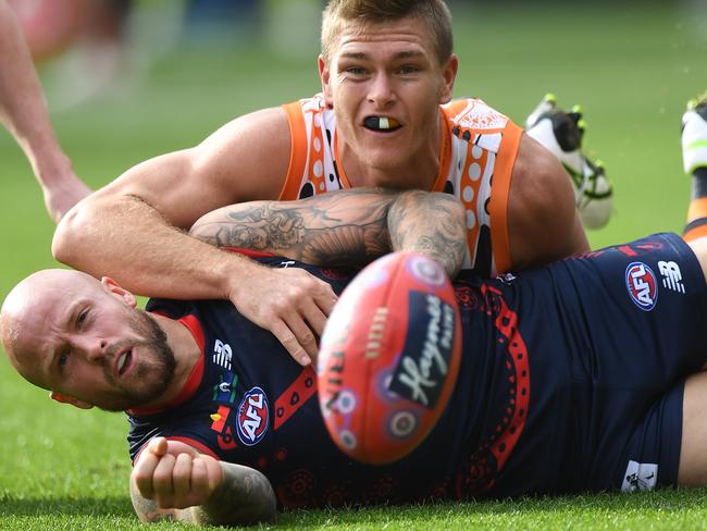 Nathan Jones under pressure from Giant Adam Tomlinson.