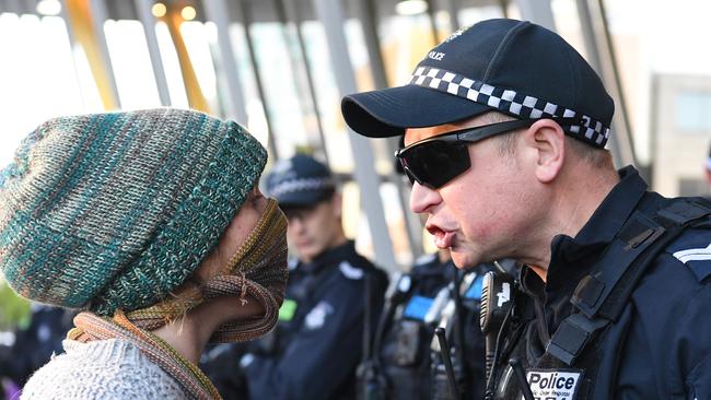 A police officer confronts a climate protester outside the conference.