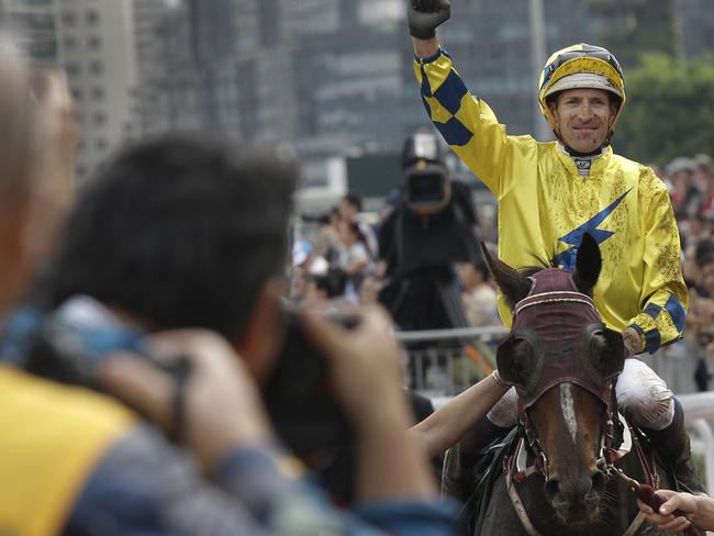 Australian jockey Hugh Bowman celebrates after winning the QEII Cup. Picture: AP