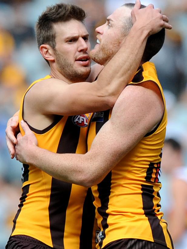 Grant Birchall hugs Jarryd Roughead