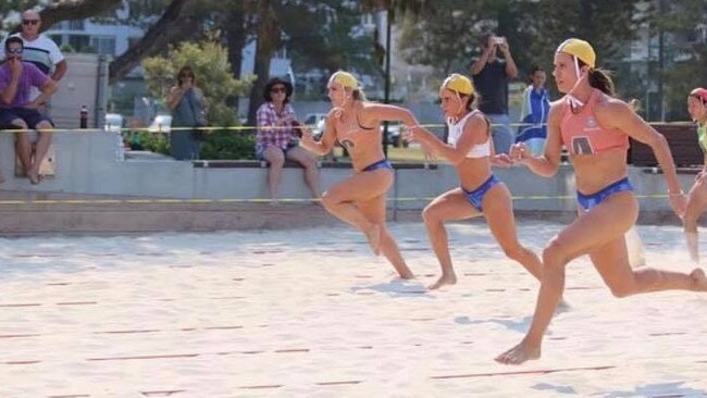 From L-R: Taylor Stickler, Casie Fyall and Bree Masters sprint towards the finish line at Kurrawa beach. Picture supplied.