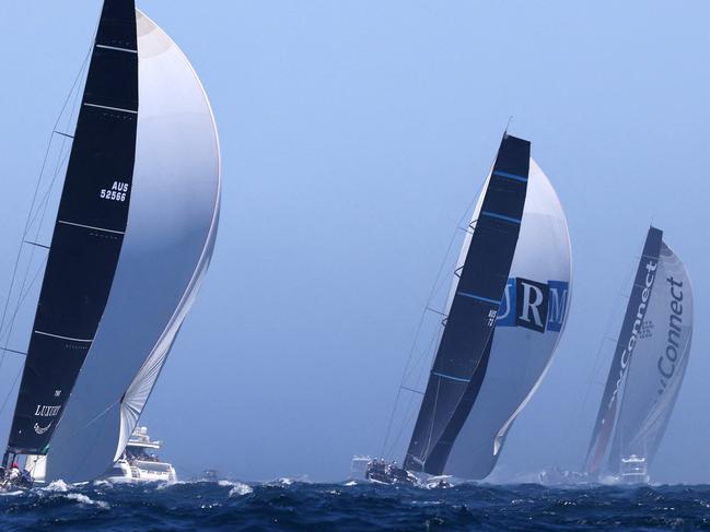 Yachts, (L-R) Wild Oats, Alive, URM Group and LawConnect compete at the start of the Sydney to Hobart yacht race on December 26, 2022 on Sydney Harbour. (Photo by DAVID GRAY / AFP) / -- IMAGE RESTRICTED TO EDITORIAL USE - STRICTLY NO COMMERCIAL USE --