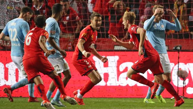 Adelaide’s Ben Halloran, right, celebrates after scoring the winner against Melbourne City in the final minutes of extra time at Coopers Stadium. Picture: Getty Images