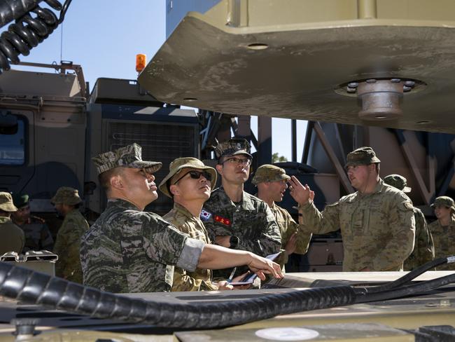 Republic of Korea Armed Forces officers and Australian Army soldier discuss the details of a HX-81 truck, during a tour of the Townsville Field Training Area for International Observers during Exercise Talisman Sabre 2021 (TS21). Picture: LACW Emma Schwenke