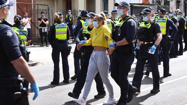 Police detain an anti-lockdown protester at Melbourne's Queen Victoria Market in September.