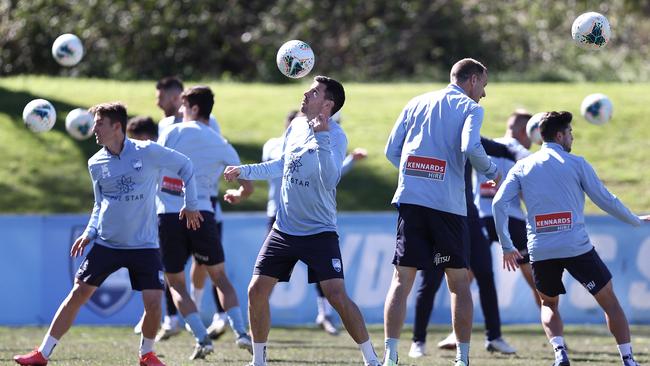 The Sydney FC squad warms up at Macquarie Uni