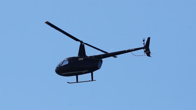 A helicopter patrolling over Burleigh on Sunday. Picture: Jason O'Brien