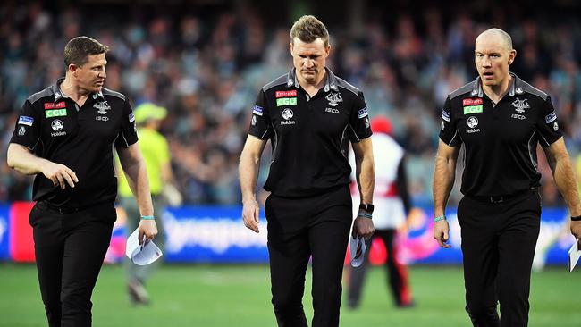 Magpies assistant Scott Burns (left) and Brenton Sanderson flank Nathan Buckley. Picture: Getty Images