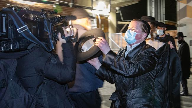 A man clashes with a TV cameraman. Picture: Mark Stewart