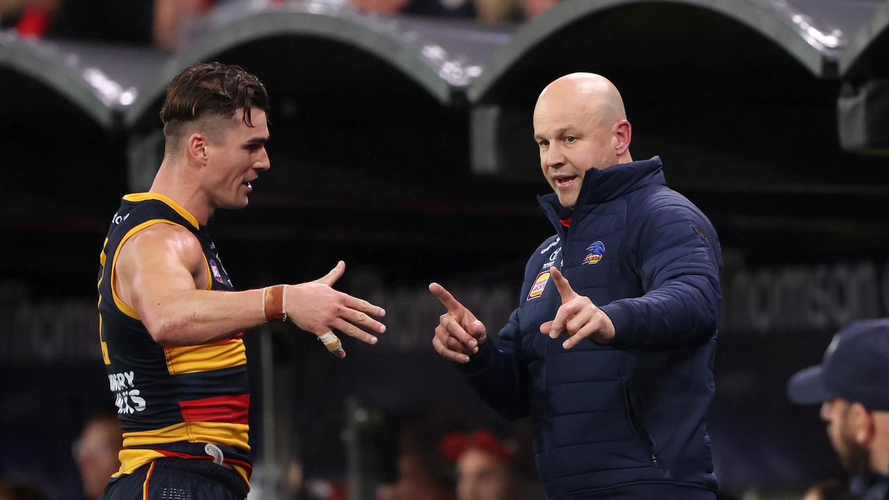 Matthew Nicks talks to Ben Keays on the bench. Photo by Sarah Reed/AFL Photos via Getty Images