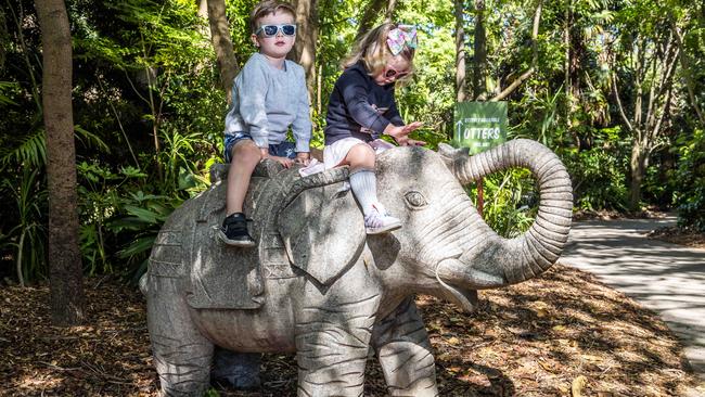 Melbourne Zoo reopens after lockdown. Weaver siblings Ashton, 4 and Poppy, 2 play on an elephant statue. Picture: Jake Nowakowski