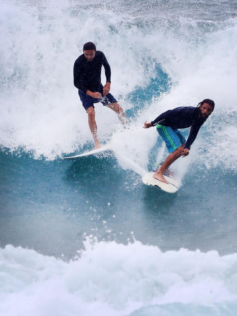 Drop ins were a plenty Surfers as large numbers of surfers line up for a wave at Burleigh Heads as wet weather descended over the Gold Coast. Photo: Scott Powick NEWSCORP