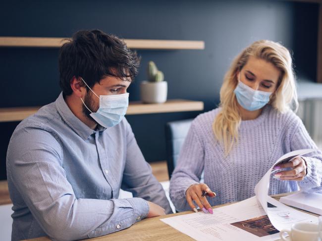 Business people working with face mask in office.