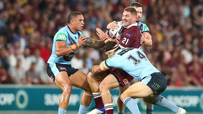 Brenko Lee of the Maroons is tackled during game three of the State of Origin series. (Photo by Chris Hyde/Getty Images)