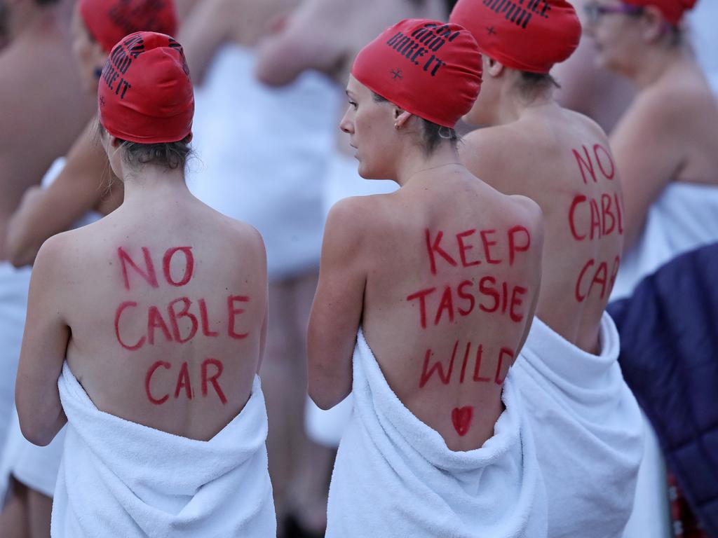 DARK MOFO 2019: Peaceful anti-cable car protests at the nude solstice swim at Long Beach, Sandy Bay. Picture: LUKE BOWDEN