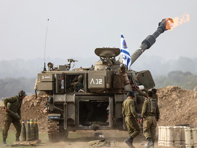 An Israeli army self-propelled artillery howitzer fires rounds from a position near the border with the Gaza Strip in southern Israel. Picture: AFP