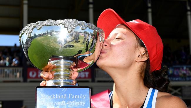 Sprinter Elizabeth Forsyth from Queensland celebrates with the winners trophy, after winning the 2018 Women's Stawell Gift. Photo: AAP