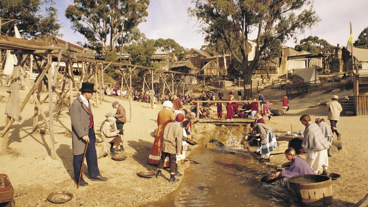 Gold Digger Shows Tourists Alluvial Gold Sand Mined in the Mine on