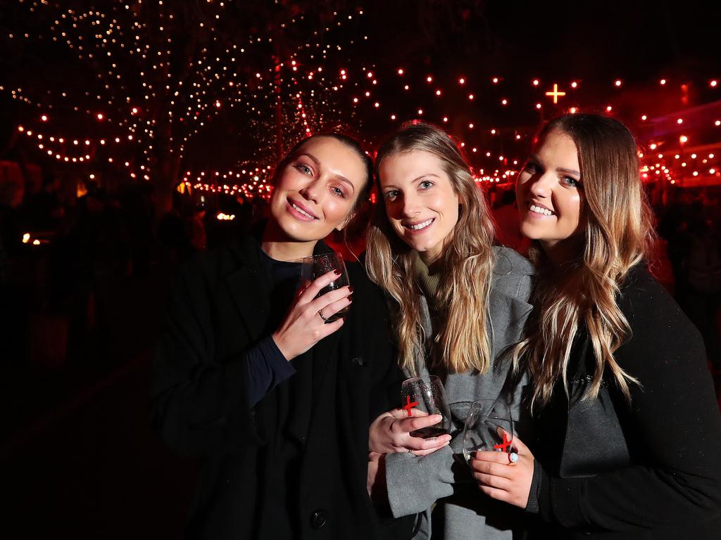 Scarlett Quamby, 25, left, Elspeth Hope 26, Sarah Maree, 25, all of Hobart, enjoying the Winter Feast during Dark Mofo in the city. Picture: NIKKI DAVIS-JONES