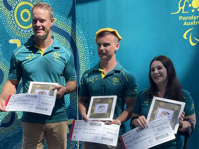 Paracanoe representatives (from left) Curtis McGrath, Dylan Littlehales and Susan Seipel receive their boarding passes and berets after being the first athletes names to Australia’s Paralympic team.