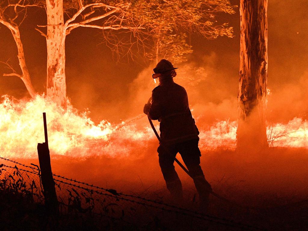 Firefighters faced a huge task to save homes and businesses as the New Year’s Eve fires raged across NSW. Picture: AAP