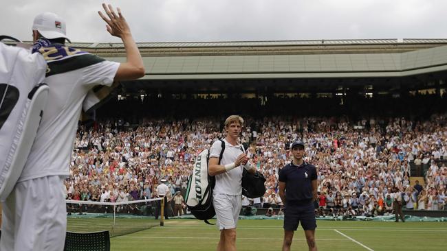 Isner, left, and Anderson leave the court after their epic encounter. Picture: AFP