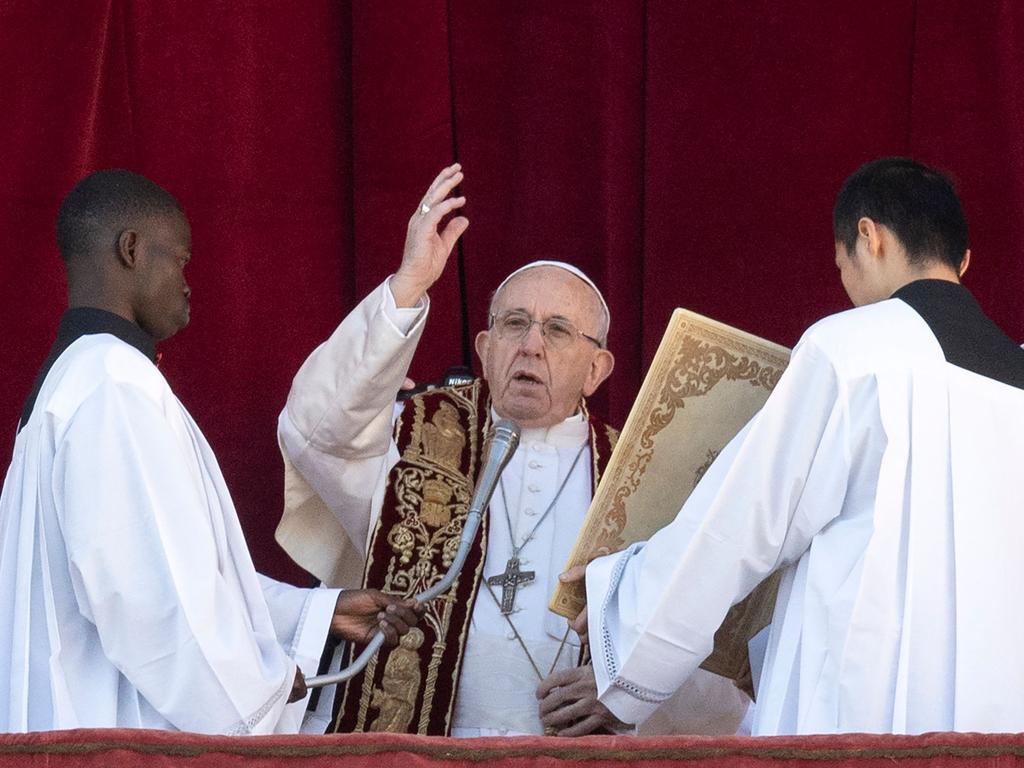 Pope Francis (C) blesses from the balcony of St Peter's basilica during the traditional "Urbi et Orbi" Christmas message to the city and the world. Picture: Tiziana Fabi/AFP