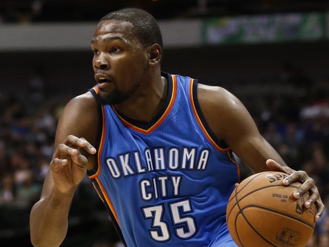 FILE - In a Friday, Oct. 10, 2014 file photo, Oklahoma City Thunder forward Kevin Durant (35) drives to the basket in front of Dallas Mavericks forward Al-Farouq Aminu (7) during the first half of a preseason NBA basketball game, in Dallas, Texas. Durant has a fractured right foot and the NBA's MVP seems likely to be sidelined for at least the start of the season. The team said Sunday, Oct. 12, 2014 in a statement he was diagnosed with a "Jones" fracture — a broken bone at the base of the small toe. (AP Photo/Jim Cowsert, File)