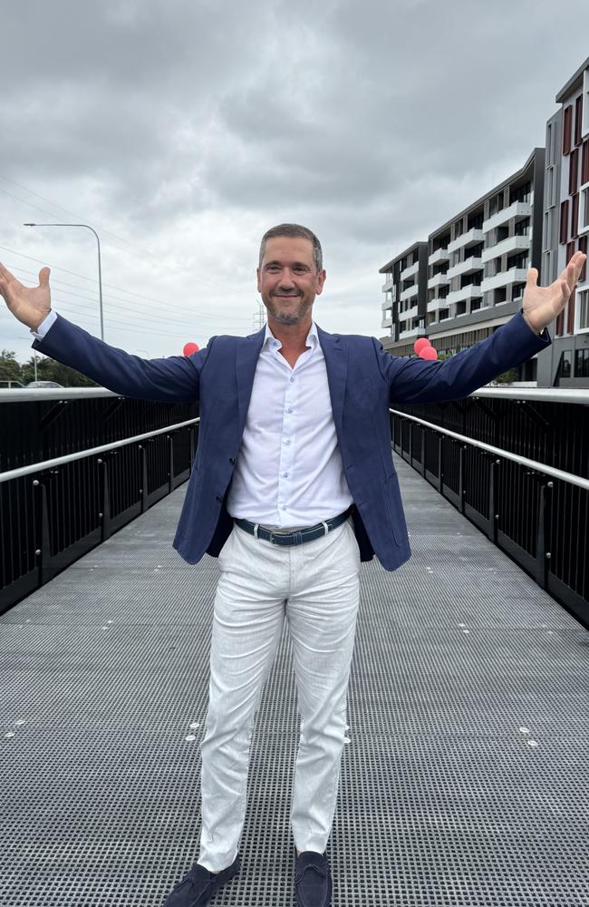 Panthera Group CEO Mario Evangelo opens a new bridge connecting The Lanes precinct at Mermaid Waters. Picture: Andrew Potts