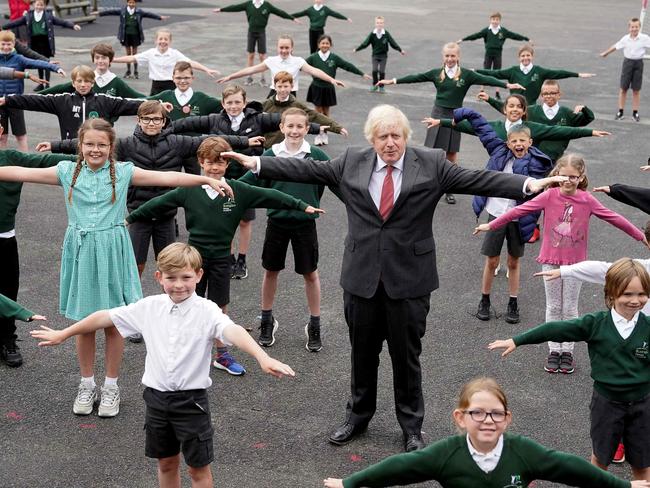 Britain's Prime Minister Boris Johnson joins pupils during a socially distanced visit to Bovingdon Primary School in Hertfordshire. Seven in 10 Brits are estimated to have contracted Covid. Picture: AFP