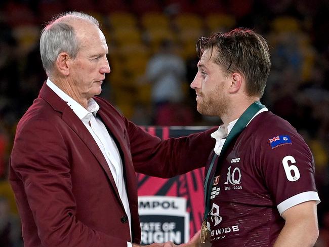 BRISBANE, AUSTRALIA - NOVEMBER 18:  Cameron Munster of the Maroons is presented with the man of the match award by  Maroons coach Wayne Bennett after game three of the State of Origin series between the Queensland Maroons and the New South Wales Blues at Suncorp Stadium on November 18, 2020 in Brisbane, Australia. (Photo by Bradley Kanaris/Getty Images)