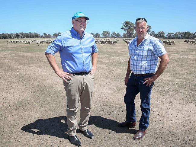 Prime Minister Scott Morrison visiting Briagolong in Gippsland , Victoria to speak with farmers about the effects of on going drought in the region.The Prime Minister inspects the dry earth on the property of sheep farmer John Freeman. Picture : Ian Currie