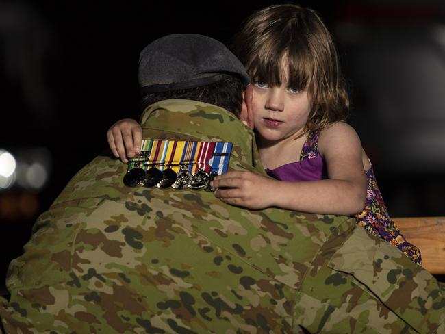 Grainia practising for their Anzac Day driveway tribute with the medals of her parents, both of whom are serving members of the ADF. Picture: Gary Ramage