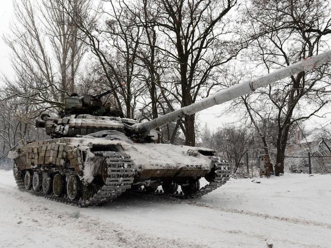 Rolling in ... a Ukrainian Army tank rides in the Donetsk region. Picture: AFP