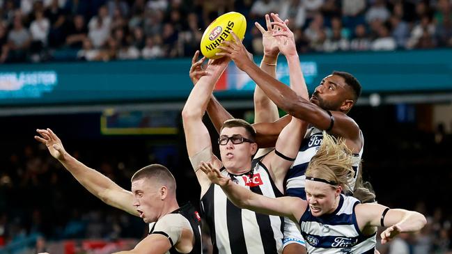 Esava Ratugolea battles Mason Cox and Darcy Cameron in the air. Picture: Dylan Burns/AFL Photos via Getty Images.