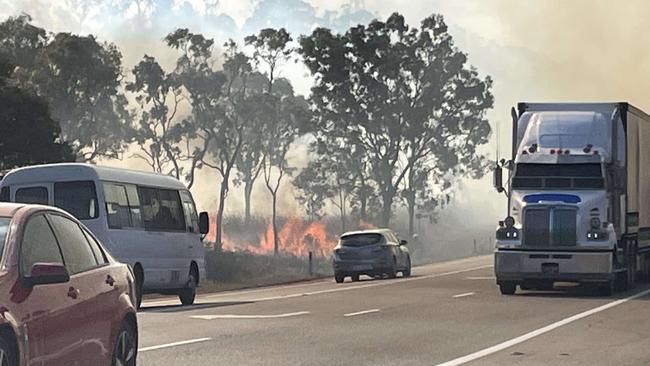 Fire crews battle a massive vegetation fire near the Bruce Highway at Julago, south of Townsville on October 16, 2024.