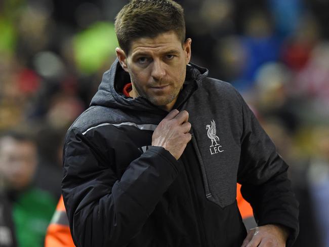 Liverpool's English midfielder Steven Gerrard prepares to take his place on the substitute's bench ahead of the English Premier League football match between Liverpool and Swansea City at Anfield in Liverpool, north west England, on December 29, 2014. AFP PHOTO / PAUL ELLIS RESTRICTED TO EDITORIAL USE. No use with unauthorized audio, video, data, fixture lists, club/league logos or “live” services. Online in-match use limited to 45 images, no video emulation. No use in betting, games or single club/league/player publications.