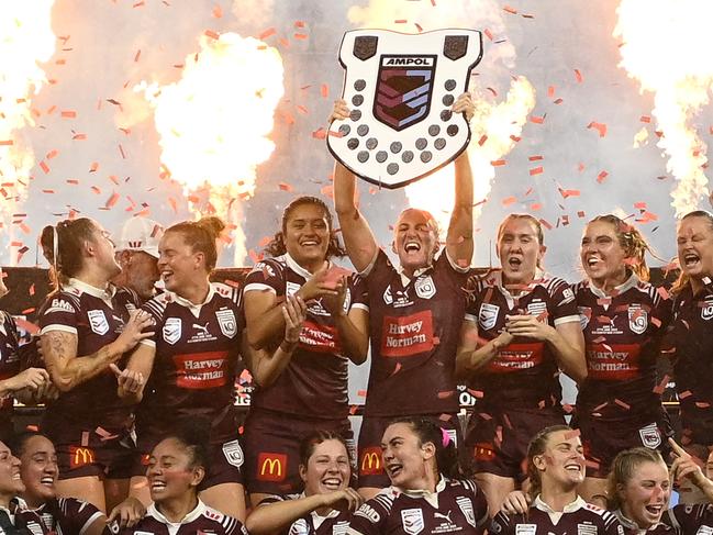 TOWNSVILLE, AUSTRALIA - JUNE 27:  Maroons players celebrate with the Women's State of Origin shield after winning game three of the 2024 Women's State of Origin series between Queensland Maroons and New South Wales Sky Blues at Queensland Country Bank Stadium on June 27, 2024 in Townsville, Australia. (Photo by Ian Hitchcock/Getty Images)