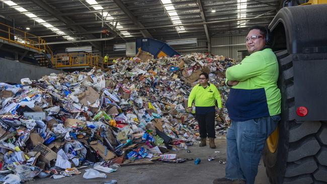 Resource recovery leading hand Wasa Teaurere (centre) and recycling operator Makea Tupa (right) in front of a pile of material from kerbside waste collection. Picture: Brian Cassey