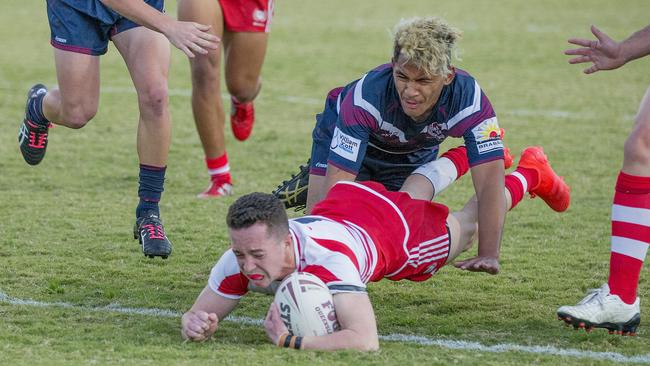 Defending champions Palm Beach Currumbin (red) host runners up Ipswich State High in the opening round of the 2020 Langer Cup at Pizzey Park. Palm Beach Currumbin's Tom Weaver crossing over the line and Ipswich State High's Deijion Leugaimafa. Picture: Jerad Williams