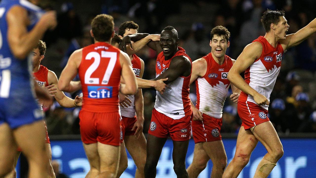 Aliir Aliir of the Swans celebrates the winning goal with teammates against North Melbourne.