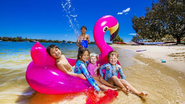 Ammon Matthews, 7, Liliana Matthews, 10, Lexi Norford, 4, Carter Matthews, 5 and Auron Matthews, 11, from Yarrabilba enjoy the hot weather at The Spit on the Gold Coast. Picture: Nigel Hallett