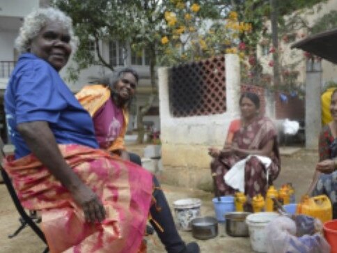 Janet Marawarr and D. Wurrkidj with colourists from Tharangini Studio, Bangalore, in 2023. Picture: Jessica Stalenberg